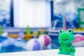 Swimming pool in kindergarten. Rubber toy frog on the side of the pool. Royalty Free Stock Photo