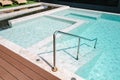 Swimming Pool Ladder and Sun Lounger in Poolside, Luxury Outdoor Swim Pool and Modern Decoration of Resort Hotel. Relaxation Royalty Free Stock Photo