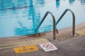 Swimming pool with lader and sign