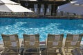 Swimming Pool With Lounge Chairs And Sunshades Royalty Free Stock Photo