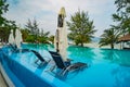 Swimming pool luxury holiday hotel, amazing view. Relax near pool with handrail, sunbeds, sun loungers and parasols waiting for Royalty Free Stock Photo