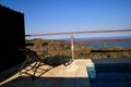 Swimming pool of luxury holiday villa, amazing nature view landscape sea. Relax near swimming pool with handrail, deck chairs. Royalty Free Stock Photo