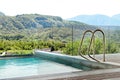 Swimming pool on luxury hotel terrace, mountain background Royalty Free Stock Photo