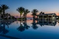 Swimming pool at a luxury resort at night, dawn time. Royalty Free Stock Photo