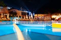 Swimming pool at a luxury resort at night time Royalty Free Stock Photo