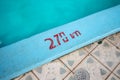 Swimming pool with 2.70m depth marker painted in red Royalty Free Stock Photo