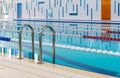 Swimming pool with marked red and white lanes. Empty swimming pool without people with quiet standing water.