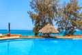 Swimming pool overlooking ocean. Tropical vacations concept Royalty Free Stock Photo