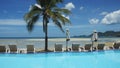 Swimming pool with palm tree near the sea on Koh Samui. Royalty Free Stock Photo