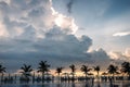 Swimming pool, palm trees around, An empty area with many sunbed Royalty Free Stock Photo