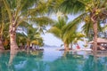 Swimming pool, Palm trees and the beach in front of. Royalty Free Stock Photo