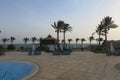 Swimming pool with palm trees at morning, Marsa Alam, Egypt. Recreation near the pool in expensive mansion. 3d illustration. Royalty Free Stock Photo