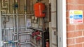 A swimming pool plant heating room with warning sign outside