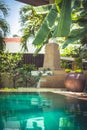 Swimming pool at private tropical villa with palm trees and Asian decorations elements Royalty Free Stock Photo