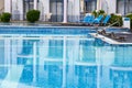 Swimming pool with a reflection of the hotel on a mirrored surface of the water. Without people