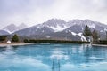 Swimming pool overlooking mountain range against sky during winter