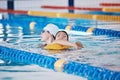 Swimming pool rescue, or woman with lifeguard for emergency, drowning accident or dangerous activity. Fitness training