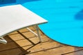Swimming pool side white furniture deck chair summer time vacation season resort relaxation space wallpaper background pattern Royalty Free Stock Photo