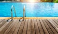 pool with stainless steel ladder stairs and wooden deck