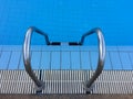 Swimming pool with stair and blue water Royalty Free Stock Photo