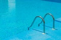 Swimming pool with stair and blue water.