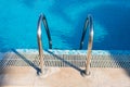 swimming pool stair in blue water Royalty Free Stock Photo