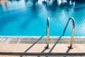 swimming pool stair in blue water Royalty Free Stock Photo