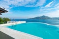 Swimming pool with stair on top of roof deck building looking at view tropical sea ,Luxury beach villa house with sea view Royalty Free Stock Photo