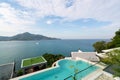 Swimming pool with stair on top of roof deck building looking at view tropical sea ,Luxury beach villa house with sea view Royalty Free Stock Photo