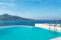 Swimming pool with stair on top of roof deck building looking at view tropical sea ,Luxury beach villa house with sea view Royalty Free Stock Photo