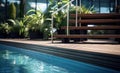 Swimming pool with stair and wooden deck at hotel. Royalty Free Stock Photo