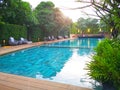 Swimming pool with stair and wooden deck at nice resort Royalty Free Stock Photo