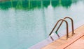 Swimming pool with stair and wooden deck Royalty Free Stock Photo