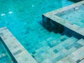 Swimming pool steps with clear water surface background. Royalty Free Stock Photo