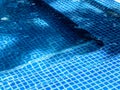 Swimming pool steps with clear water surface background, nobody. Abstract pool texture, underwater pattern blue background. Royalty Free Stock Photo