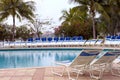 Swimming pool and sun loungers Royalty Free Stock Photo