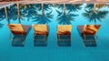 Swimming pool with sun loungers and palm trees in the background Royalty Free Stock Photo