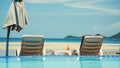 Swimming pool with sunbeds and cocktail near the sea on Koh Samui. Vacation concept. Royalty Free Stock Photo