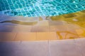 Swimming pool with sunny reflections Royalty Free Stock Photo