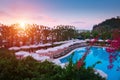 Swimming pool with sunshades and lounge chair Royalty Free Stock Photo