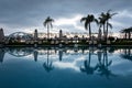 Swimming pool with sunshades and lounge chair Royalty Free Stock Photo