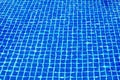 Swimming pool surface texture close up top view, blue water background, caustics ripple, swimming pool tiled bottom backdrop, sea Royalty Free Stock Photo