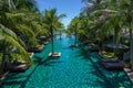 Swimming pool surround with coconut tree and bangalows at seaside resort Royalty Free Stock Photo