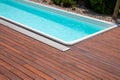 Swimming pool with teakwood flooring stripes summer vacation, teak wood decking