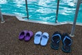 Swimming pool. Three pairs of rubber slippers standing next to each other - men`s, women`s and children`s. Family subscription Royalty Free Stock Photo