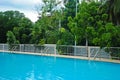 Swimming pool with three stair at hotel with sunny reflections