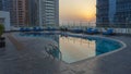 Swimming pool on top of building, sunset scene in Dubai, United Arab Emirates