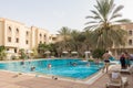 Swimming pool with tourists near Sahara desert