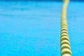 Swimming pool with transparent water, with yellow indicator float line.