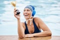 Swimming pool, trophy and a winner sports woman in water, feeling proud after a competitive race. Gold, award or Royalty Free Stock Photo
